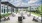 Outdoor resident lounge at Colina Weho luxury apartments in Birmingham, AL featuring grilling stations, fire pit seating, and string lighting.