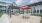 Modern outdoor dining area at Colina Weho featuring shaded pergolas, picnic tables, and contemporary community seating.