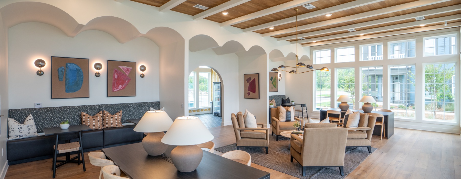 Open-concept resident lounge at Colina Weho luxury apartments with comfortable seating, contemporary lighting, and large windows